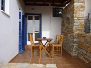 a wooden table and chairs on a patio at Vasilis Ios Place II in Ios Chora