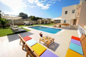 a villa with a swimming pool and a patio at Villa Victoria - A Private Family Gem in Gállos