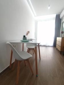 a table and a chair in a room at Sfendamos Residence Kavala in Kavála