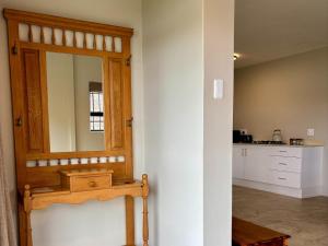 a bathroom with a mirror on a wall at Shiloh Lodges Tweefontein in Mooiriver