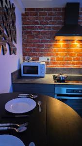 a kitchen with a table and a microwave on a counter at Le Good Vibes in Dieppe
