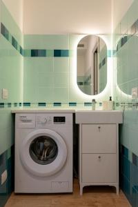 a washing machine in a bathroom with a sink at Brezza marina in Mola di Bari