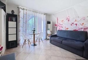 a living room with a couch and a table at Proche de Monaco appartement devant piscine in Beausoleil
