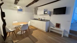 a small kitchen and dining room with a table and chairs at Glicine in Stresa