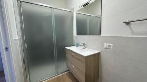 a bathroom with a shower and a sink and a mirror at Glicine in Stresa