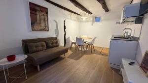 a living room with a couch and a table at Glicine in Stresa +13 photos