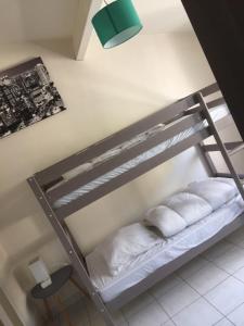 a bunk bed with two white pillows on it at la GRIERE in La Tranche-sur-Mer