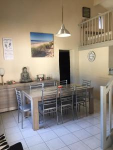 a dining room with a table and chairs at la GRIERE in La Tranche-sur-Mer