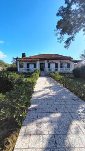a stone walkway leading to a house at Blue Pearl Molos in Mólos
