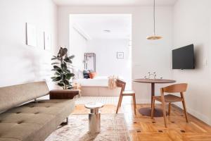 a living room with a couch and a table at Genesis-Loft Madrid in Madrid