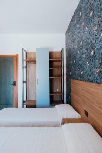 a bedroom with two beds and a wall with a mural at Hotel Acquario in Vasto +41 photos