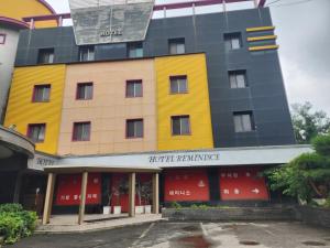 a yellow building with a sign on it at 레미니스호텔 in Dongtan