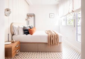 a bedroom with a bed with pillows on it at Genesis-Loft Madrid in Madrid