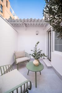 a small patio with a table and chairs and a couch at Genesis-Loft Madrid in Madrid