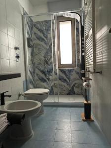 a bathroom with a shower and a toilet and a sink at Casa Palma in Rho