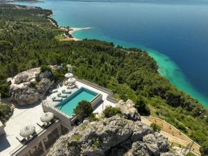 an aerial view of a house on a cliff at Villa Kuk Oaza in Makarska