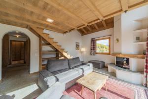 a living room with a couch and a table at Chesa Diala - Zuoz in Zuoz