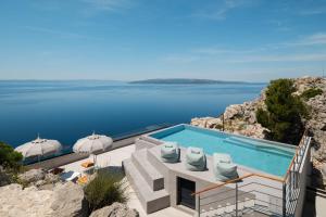 a swimming pool with a view of the water at Villa Kuk Oaza in Makarska