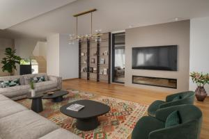 a living room with a couch and chairs and a tv at Villa Kuk Oaza in Makarska +47 photos