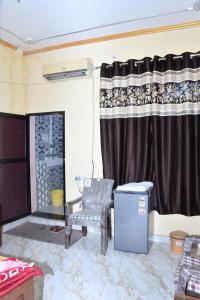 a living room with a chair and a fireplace at Sarla Resort in Sawāi Mādhopur