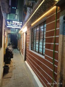 an alley with a brick building with a sign on it at THE Temple View ''Near Kashi Vishwanath'' in Varanasi
