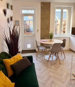 a living room with a couch and a table at LE 111 in Fécamp