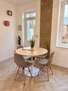 a dining room with a wooden table and chairs at LE 111 in Fécamp +25 photos