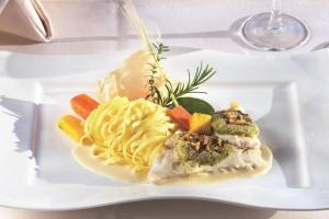 a plate of food with pasta and vegetables on it at Landhotel Steffen in Lieser