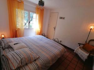 a bedroom with a large bed and a window at La licorne in Serriera