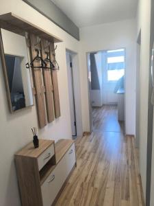 a living room with wooden floors and white walls at Ruhige Ferienwohnung NB in Neubrandenburg
