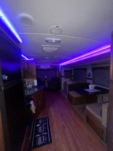 a living room with purple lights on the ceiling at Alojamiento in Tampa