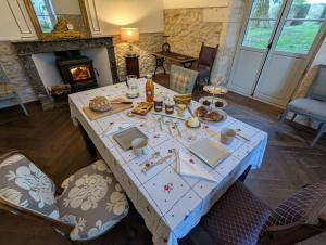 a table in a living room with a fireplace at Domaine de la Dordrona in Brantome en Perigord