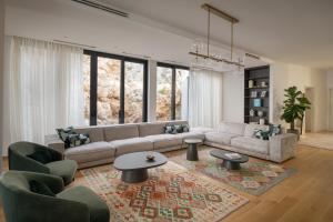 a living room with a couch and chairs and a rug at Villa Kuk Oaza in Makarska