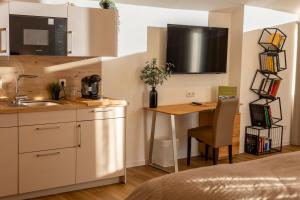 a kitchen with a sink and a table in a room at Uelser Hof in Uelsen