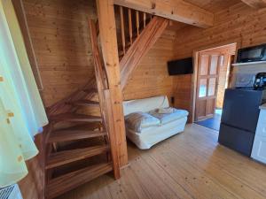 a room with a staircase in a log cabin at Roubenka pod Čerťákem in Dolní Moravice