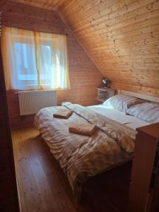 a bedroom with a bed with two towels on it at Roubenka pod Čerťákem in Dolní Moravice