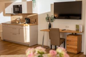 a small kitchen with a desk and a kitchen table at Uelser Hof in Uelsen +50 photos