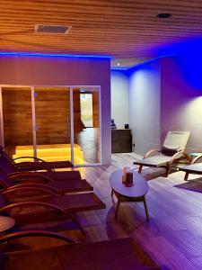 a room with a couch and chairs and a table at What Else Hotel in Saint-Vulbas