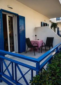 a patio with a table and chairs on a balcony at Olive Nest, Cozy Apartment in Ammoudara in Ayía Marína +16 photos