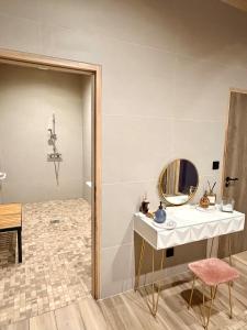 a bathroom with a sink and a mirror at What Else Hotel in Saint-Vulbas
