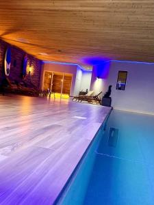 a bowling alley with blue lights in a room at What Else Hotel in Saint-Vulbas
