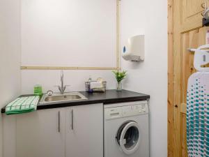 a kitchen with a sink and a washing machine at 2 Bed in Louth oc-53508 in Fotherby