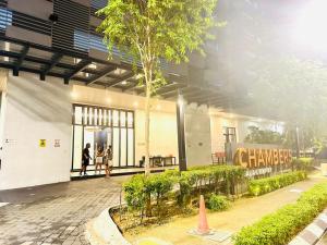 a group of people walking outside of a building at Chamber Haven KL in Kuala Lumpur