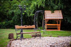 a park with a bench and a playground and a swing at Kiscsengőd Vendégház in Csengőd +10 photos
