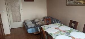 a room with a table and a couch with a teddy bear at Apartament u Basi in Sanok +26 photos