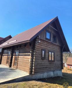 a log cabin with a gambrel roof at Roubenka pod Čerťákem in Dolní Moravice