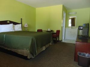 a hotel room with a bed and a desk at Westbrook Motel in Abbeville