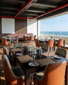 a restaurant with tables and chairs and a view of the ocean at Sea view Serenity Negombo in Negombo
