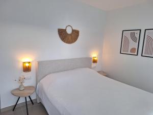 a bedroom with a large white bed and a table at Casamarcati in Calasparra +14 photos