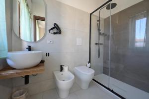 a bathroom with a toilet and a sink and a shower at Camere da Angelo in Tortolì